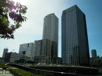 Archive photograph of Osaka’s Nakanoshima complex, showing the tower housing prosecution offices alongside other buildings and an urban road.